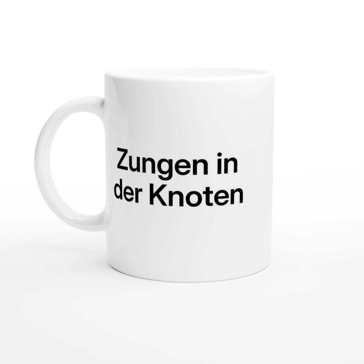 Weiße Tasse mit Aufdruck „Zungen in der Knoten“